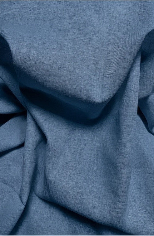 Close-up of blue fabric with folds on a white background